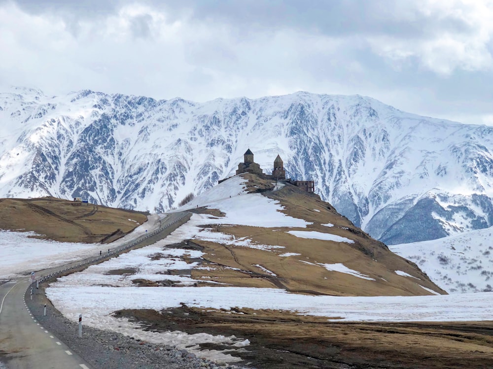 snow covered mountain under cloudy sky during daytime