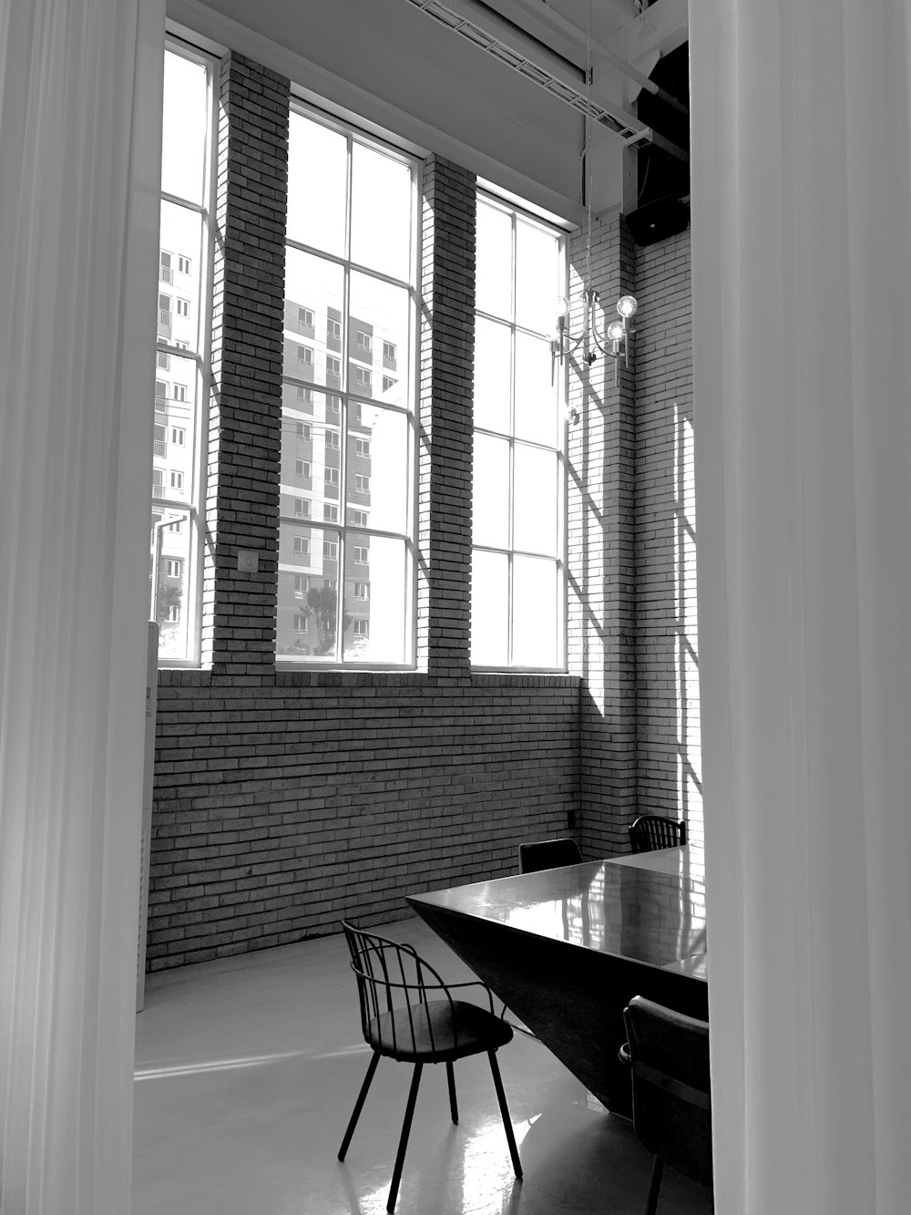 grayscale photo of table and chairs