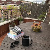 A compact Stabilaspace unit holding books and decor on a balcony with city views.