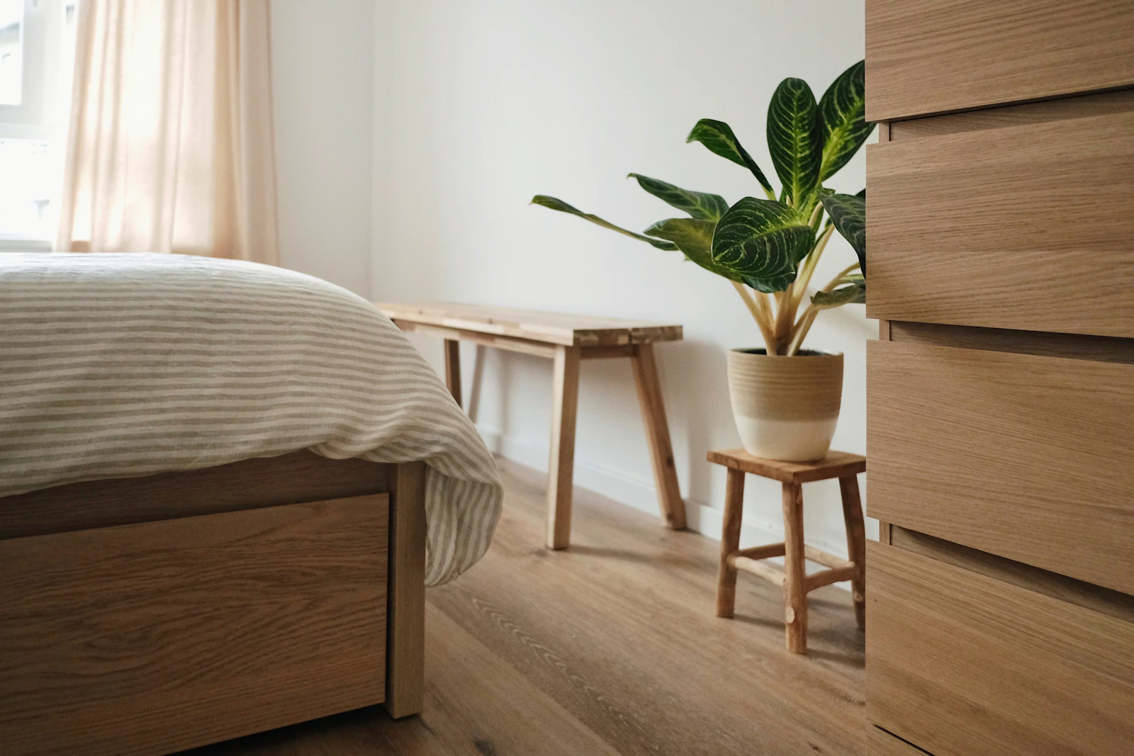 A bedroom with soft textiles and a muted palette