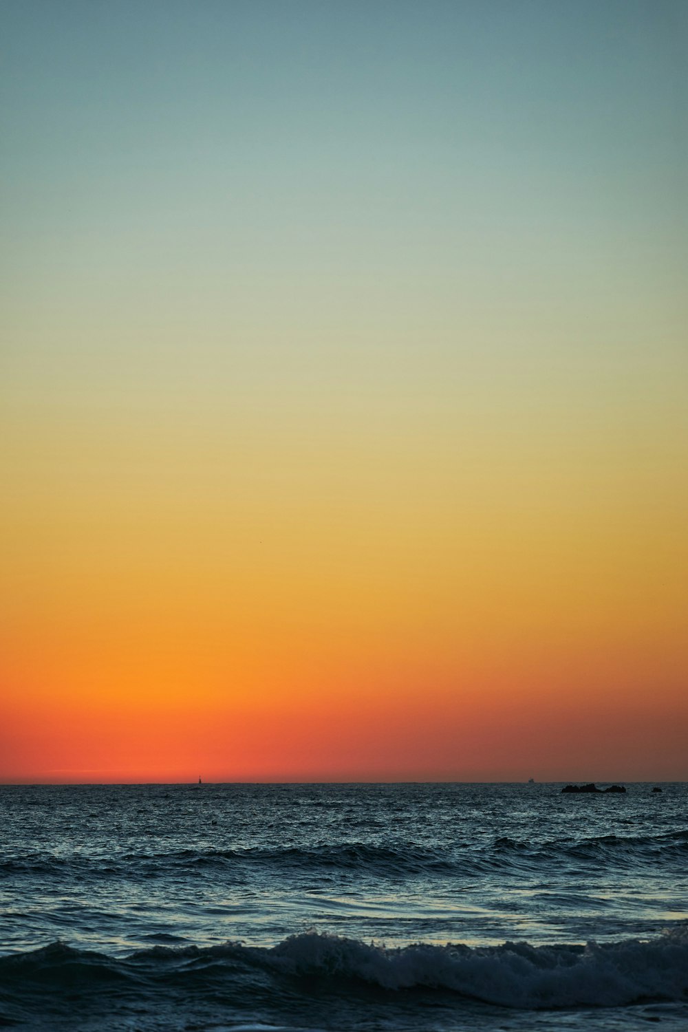 body of water during sunset