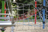 Commercial playground project with custom climbing net structures and fitness equipment.