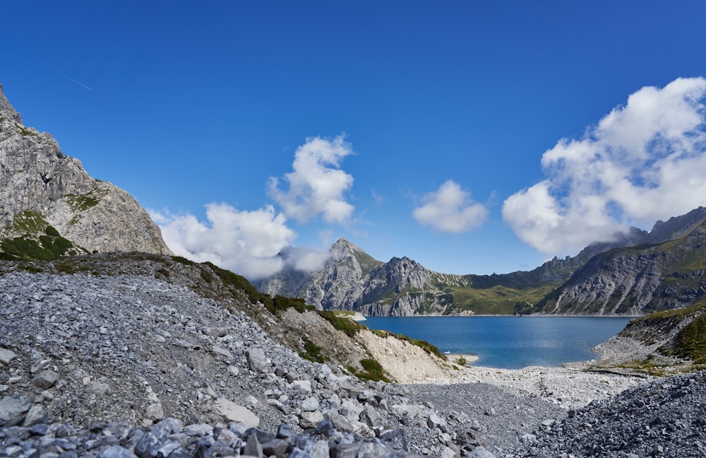 blue sea near mountain under blue sky during daytime