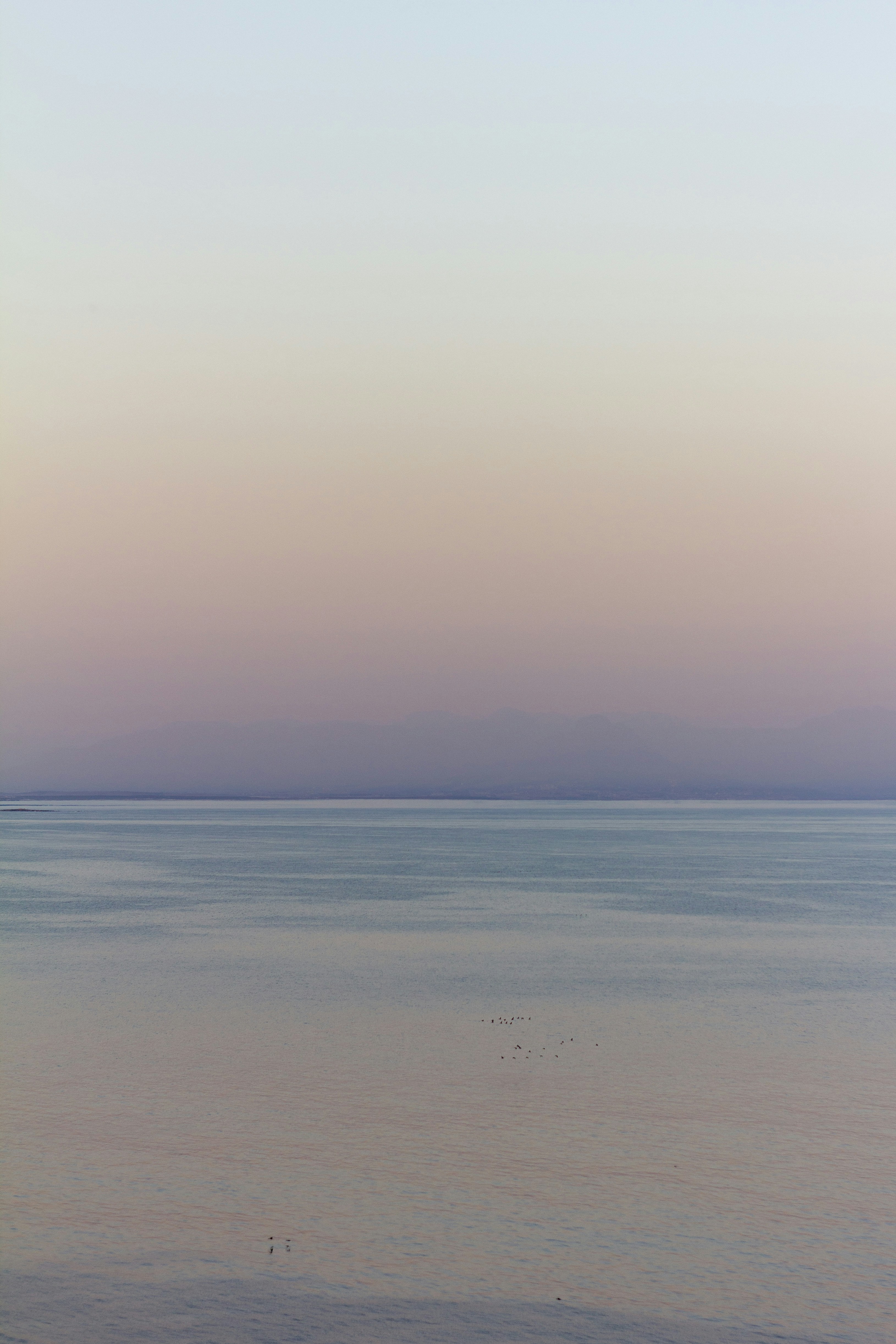 calm sea under blue sky during daytime