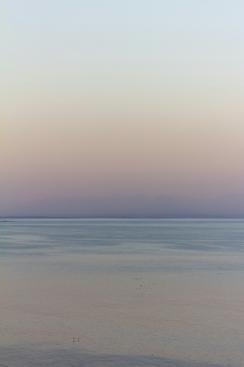 calm sea under blue sky during daytime