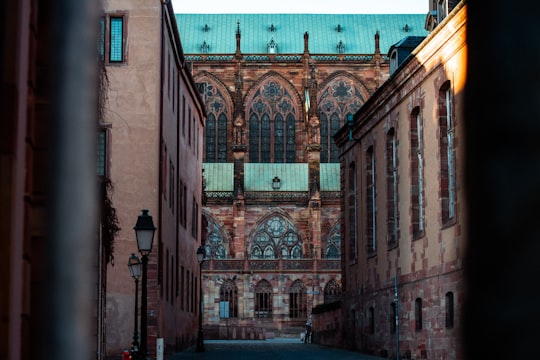 brown brick building with green metal window in Cathédrale Notre Dame de Strasbourg France