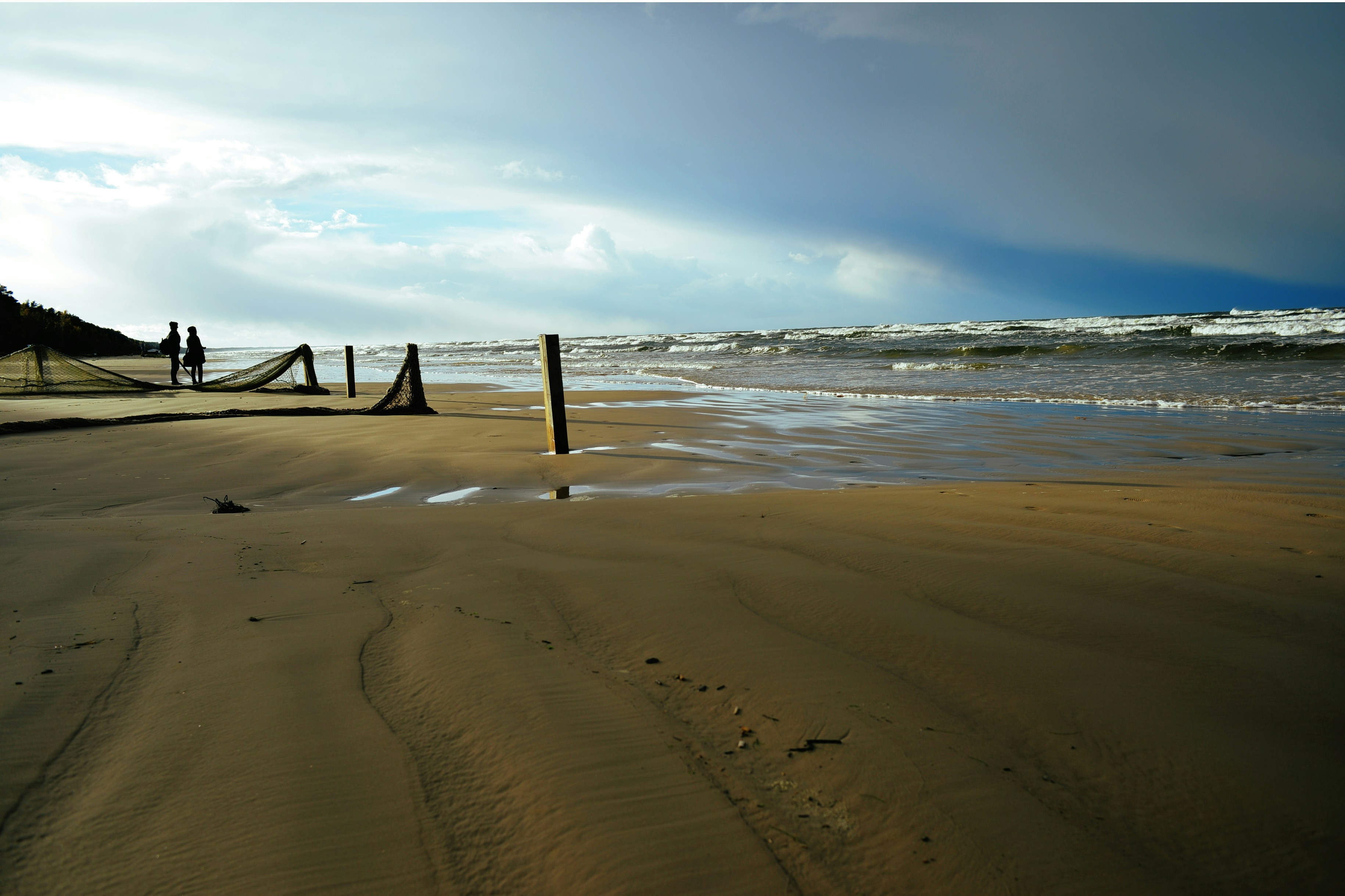 brown wooden beach dock on beach during daytime