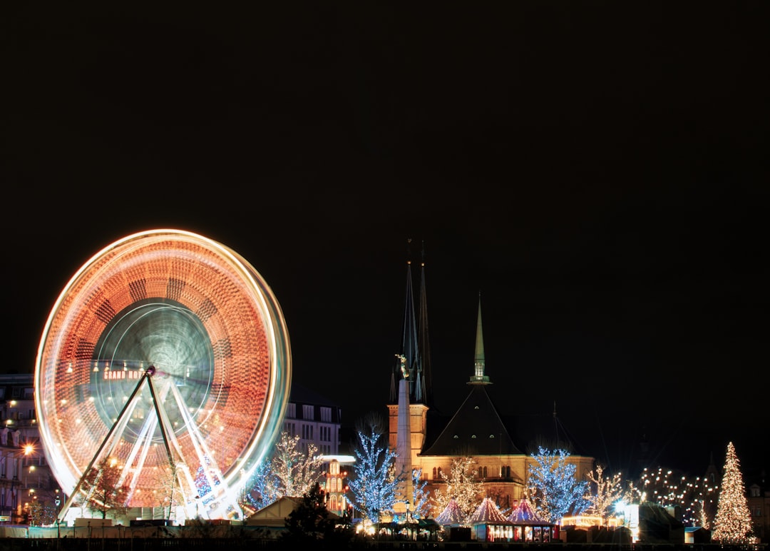 ferris wheel near city buildings during night time