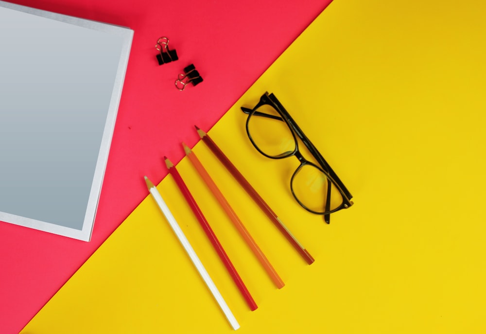 black framed eyeglasses on yellow paper