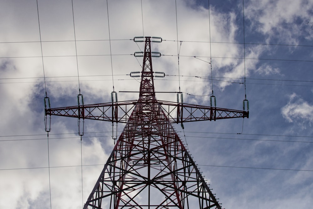 red metal tower under white clouds