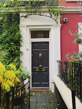 A professional installing a security door in a residential area.