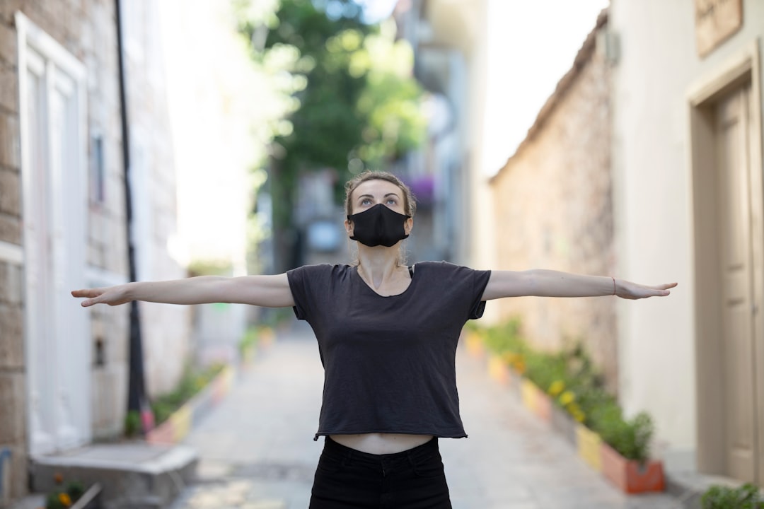 woman in black t-shirt and black shorts raising her hands