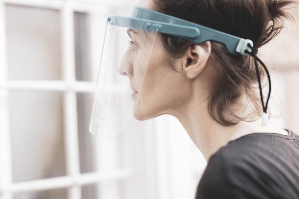 woman in black shirt wearing green framed eyeglasses