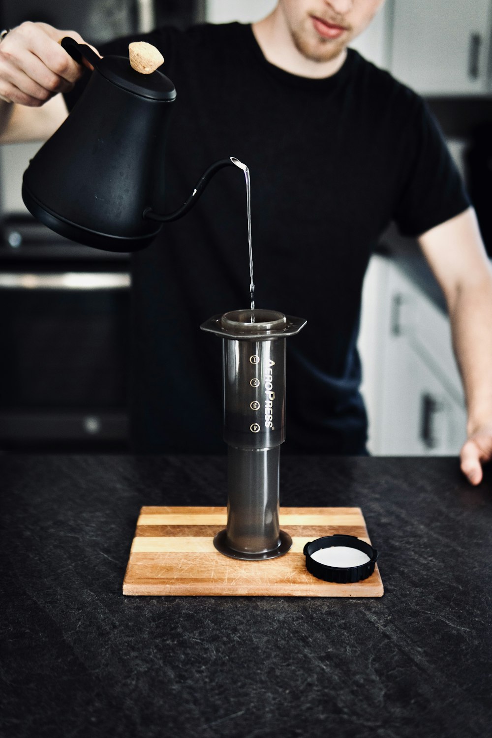 silver stainless steel cup on brown wooden tray