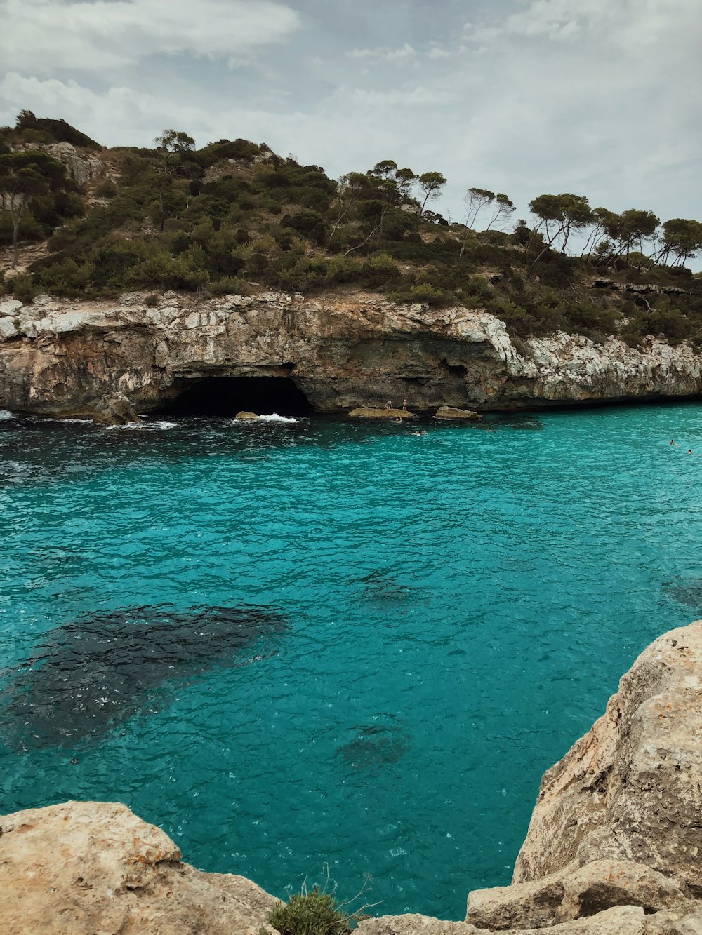 brown rock formation beside blue sea during daytime