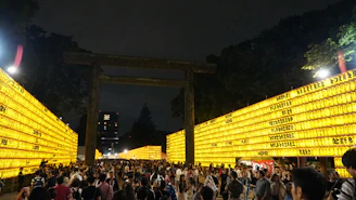 Evening event at the campus with students gathered, lanterns glowing, and lively discussions.