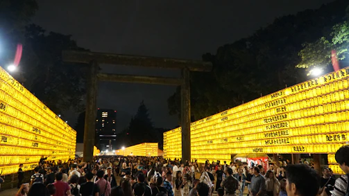 Evening event at the campus with students gathered, lanterns glowing, and lively discussions.