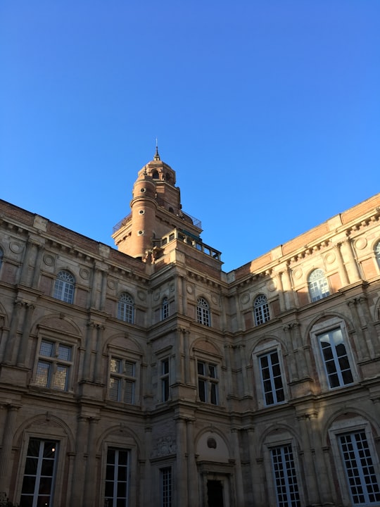 brown concrete building under blue sky during daytime in Hôtel d'Assézat France