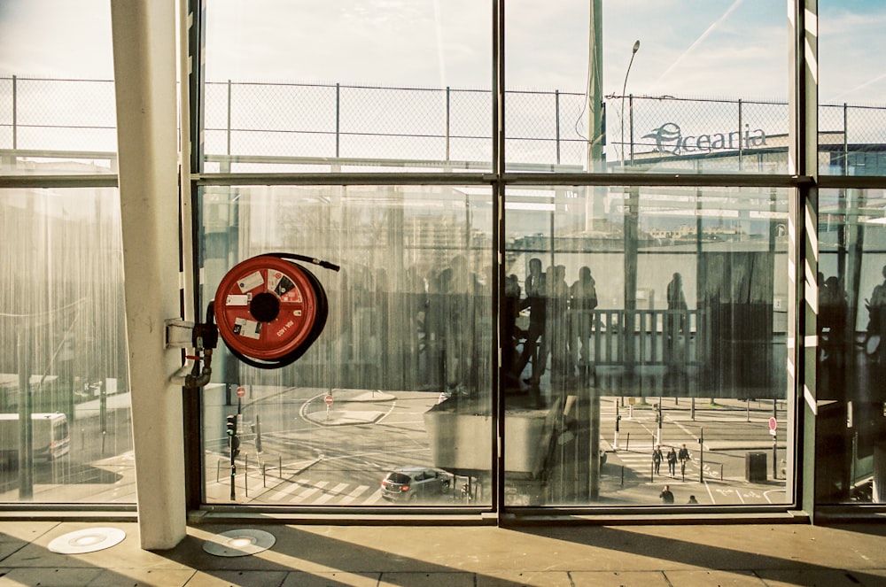 red and black round device on glass window