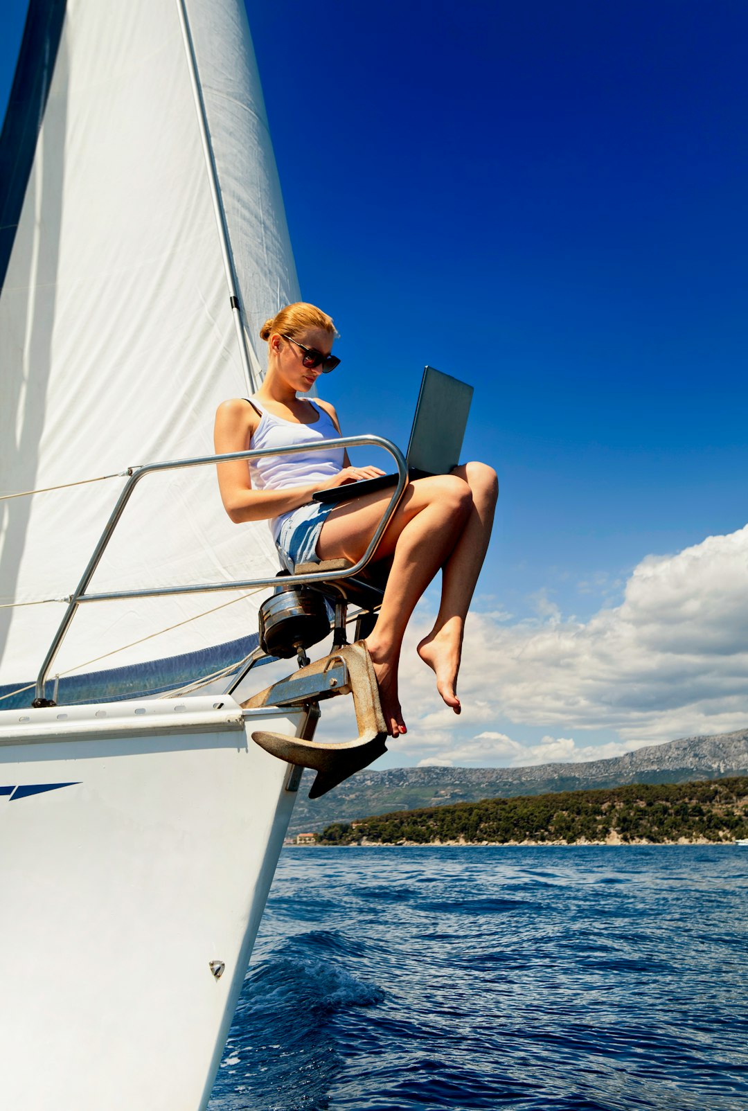 woman in white tank top sitting on white boat during daytime