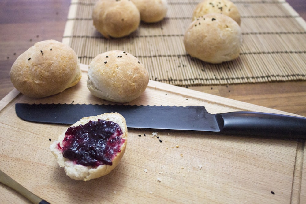 three round bread on brown wooden chopping board