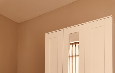 A serene dressing room featuring clean lines, muted colors, and luxurious storage solutions.