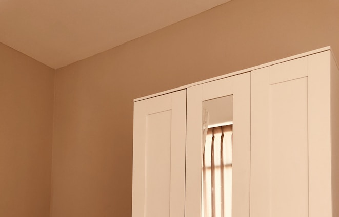 A serene, neatly organized capsule wardrobe with neutral tones and soft natural light.