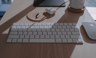 silver apple keyboard on brown wooden table