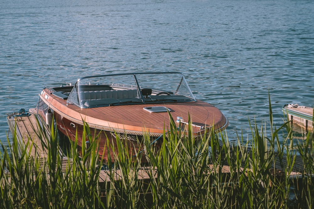 brown and white boat on body of water during daytime