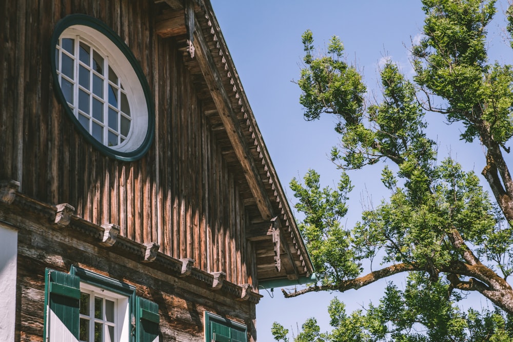 brown wooden house with white window frame