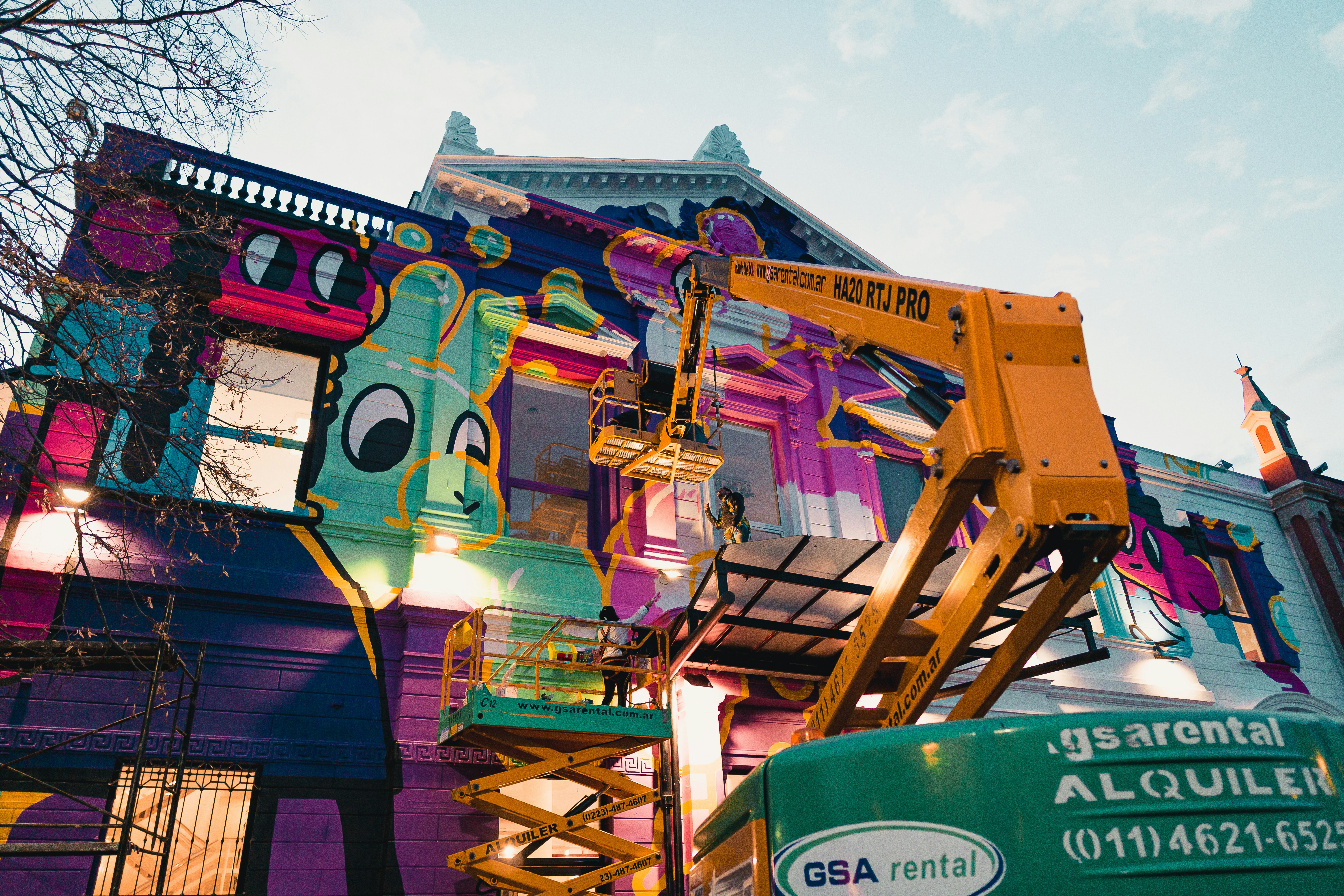 a colorful building with a crane on top of it