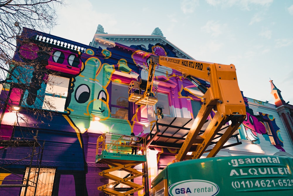 a colorful building with a crane on top of it