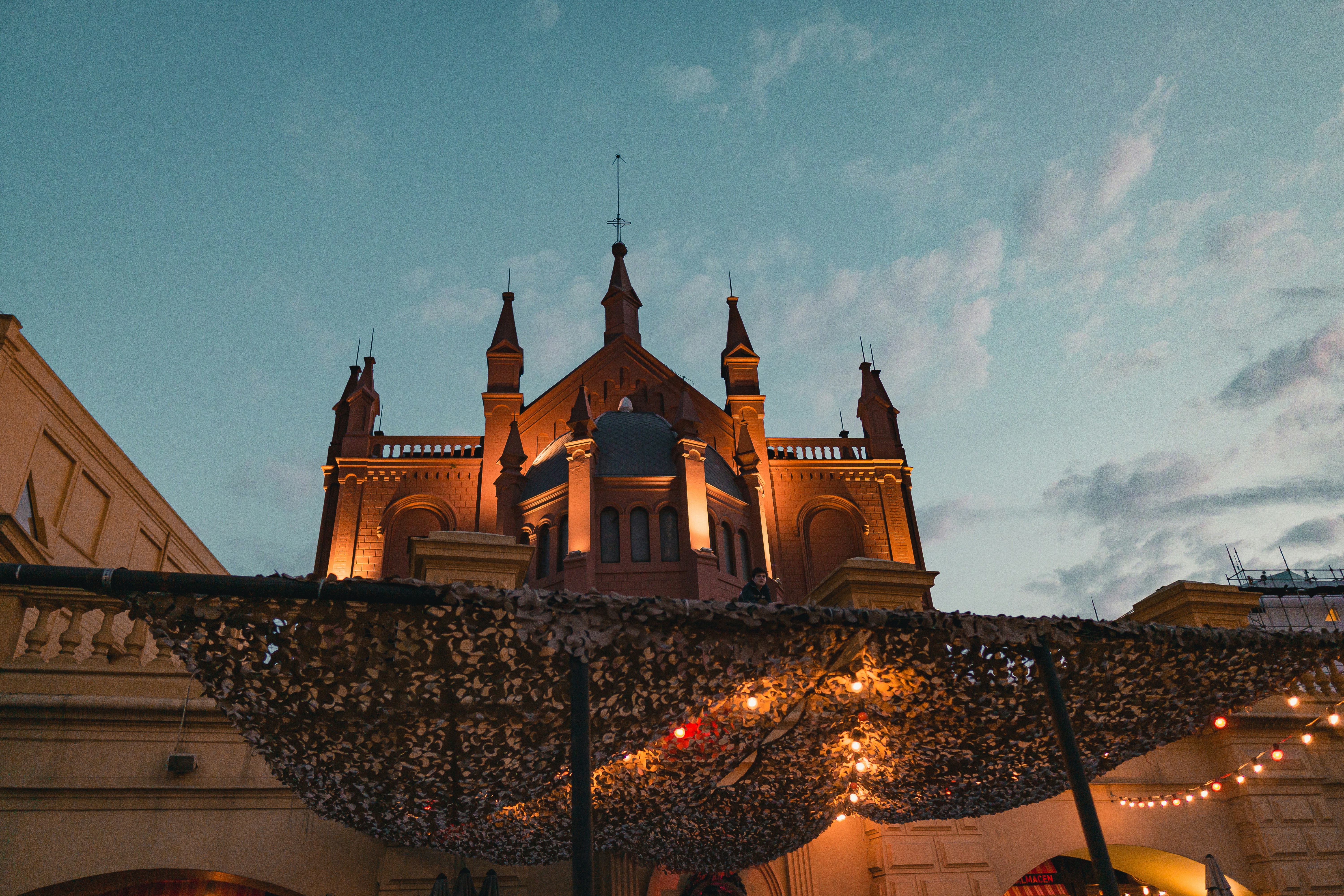 a large building with a clock tower and lights on it