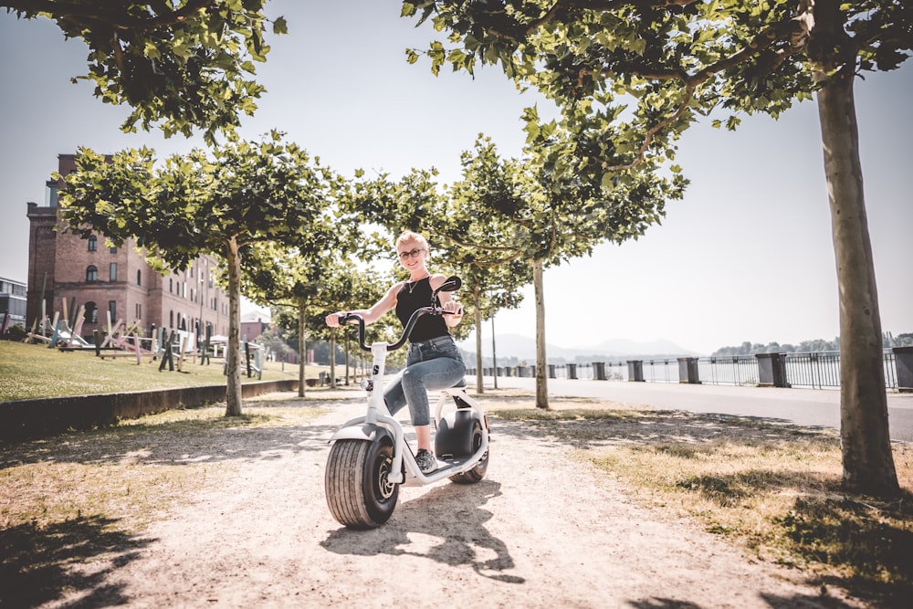 man in black shirt riding motorcycle on brown sand during daytime