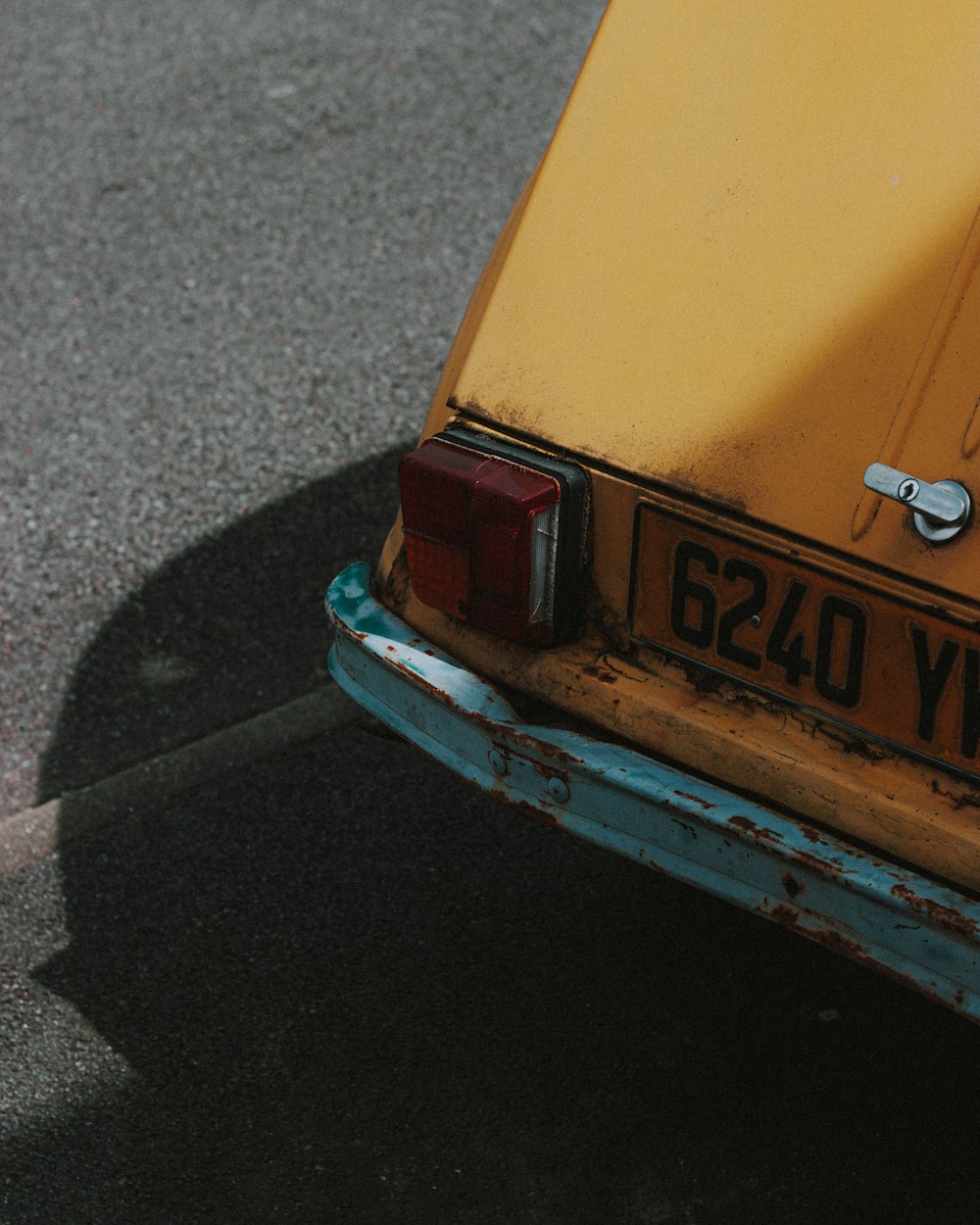 yellow and blue car on road