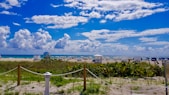 white and blue houses under blue sky and white clouds during daytime