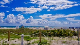 white and blue houses under blue sky and white clouds during daytime