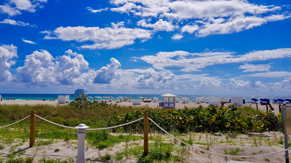 white and blue houses under blue sky and white clouds during daytime