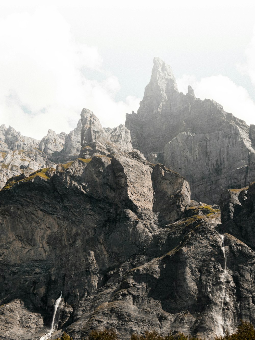 brown rocky mountain under white cloudy sky during daytime