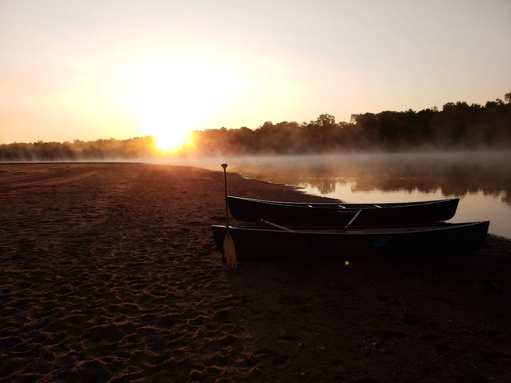 brown boat on brown sand during sunset