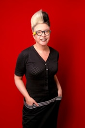 woman in black button up shirt wearing black framed eyeglasses