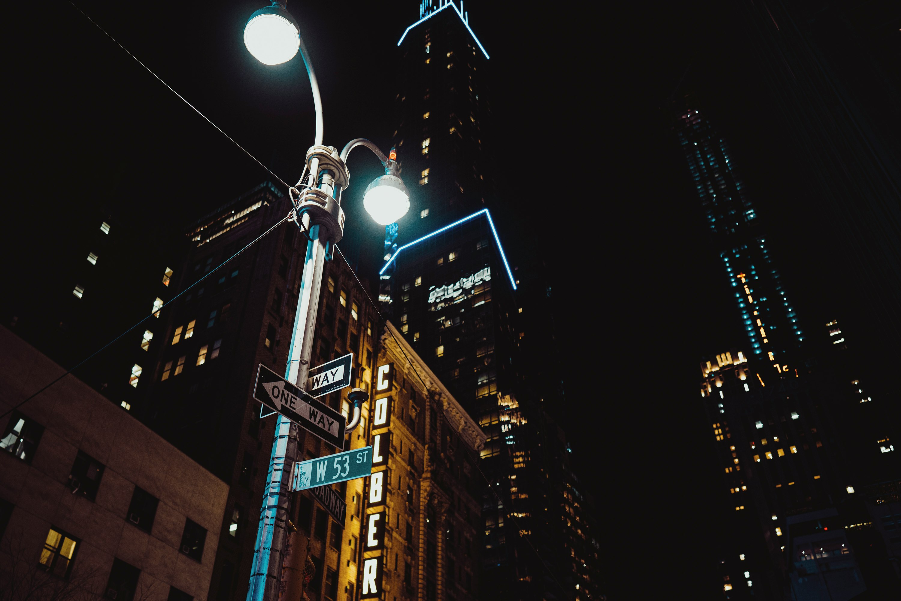 street light near high rise buildings during night time