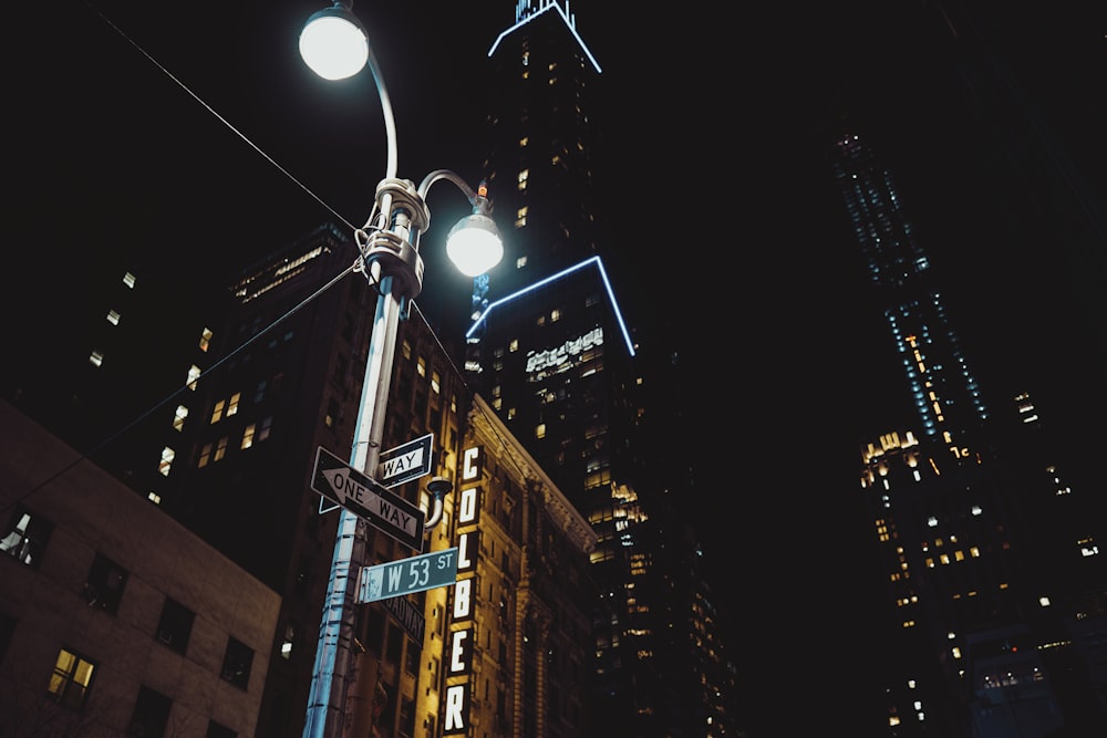 street light near high rise buildings during night time