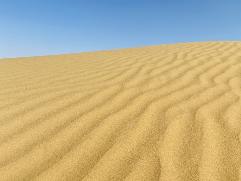 brown sand under blue sky during daytime