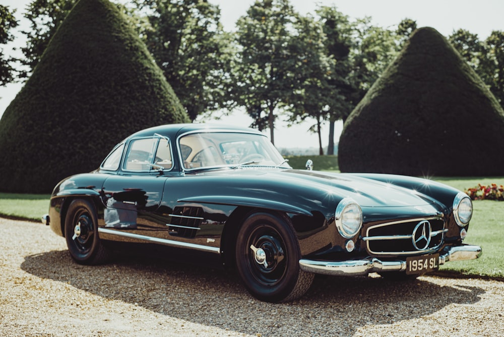 blue classic car on road during daytime