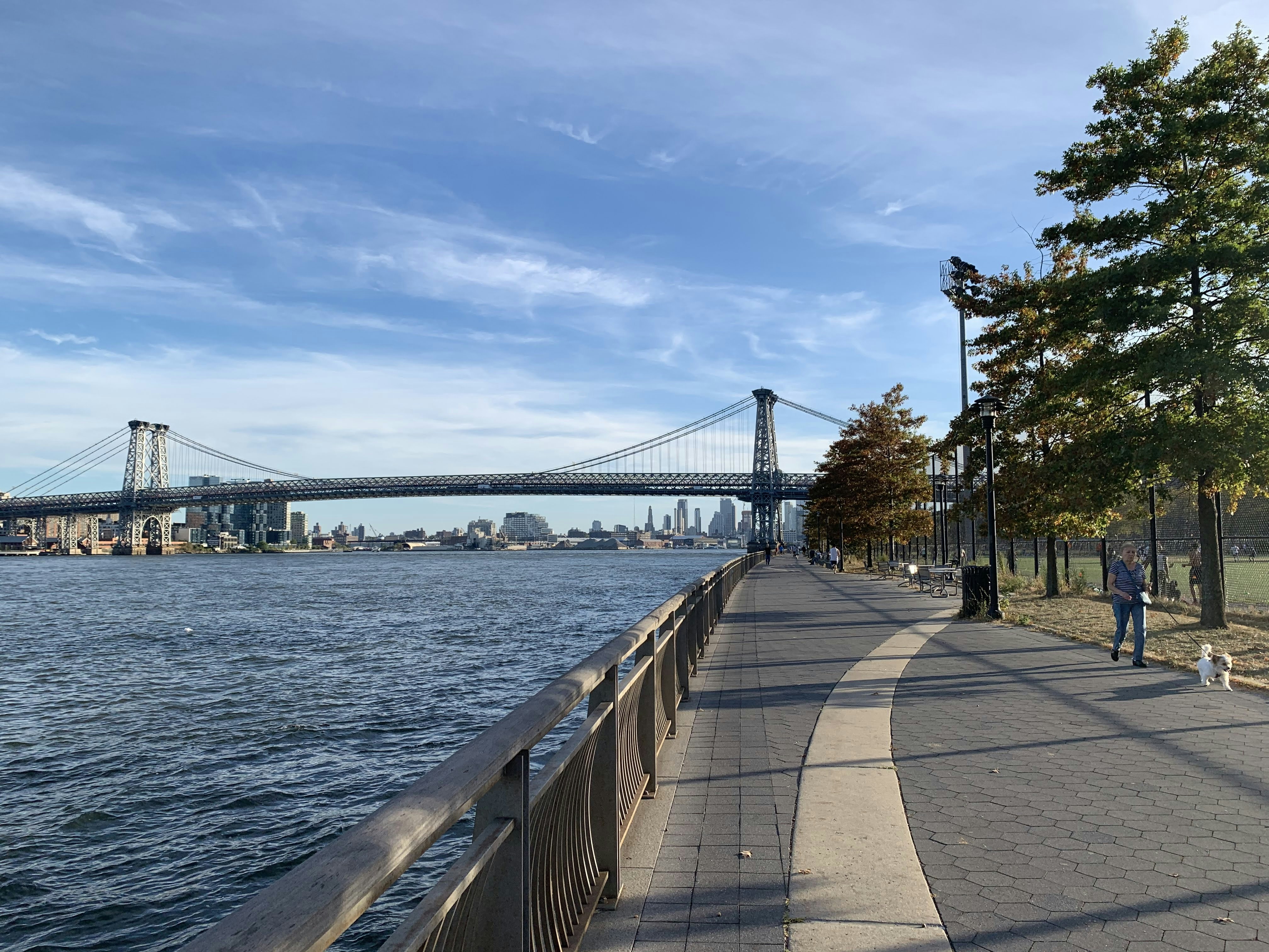 Gray concrete bridge over body of water during daytime
