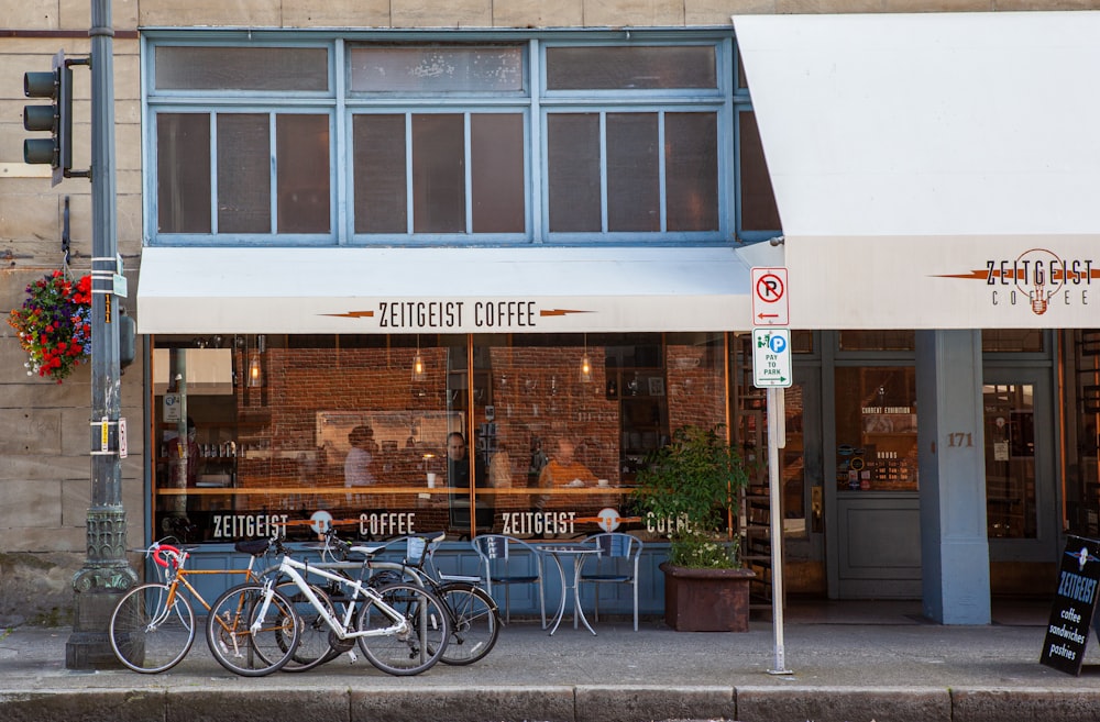 brown and white restaurant with black metal chairs and tables