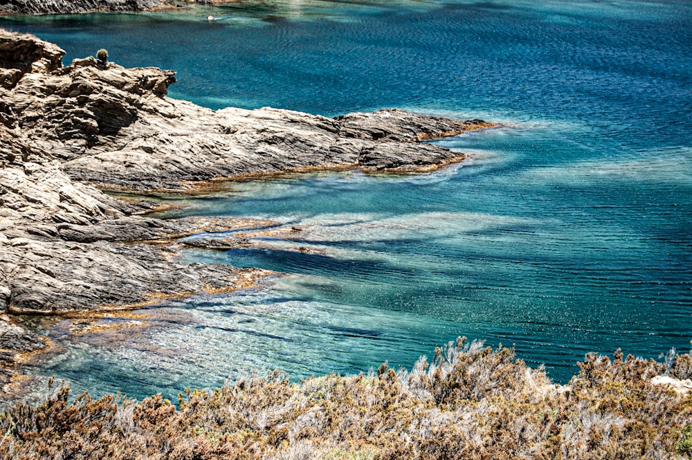 brown and gray rock formation beside blue sea during daytime