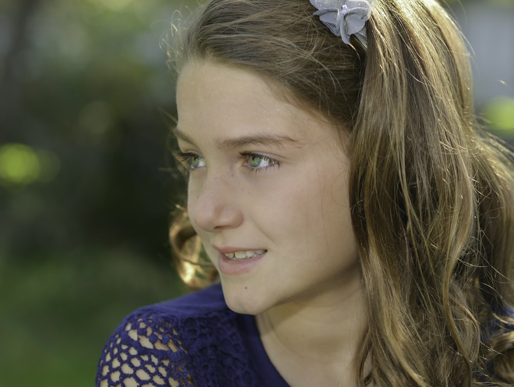 woman in blue and white polka dot shirt smiling