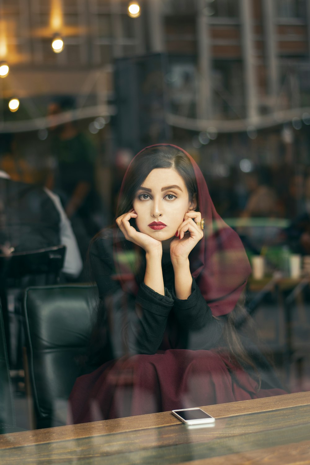 woman in black long sleeve shirt sitting on black leather couch